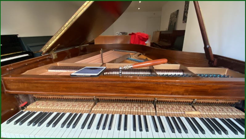 A grand piano opened for tuning